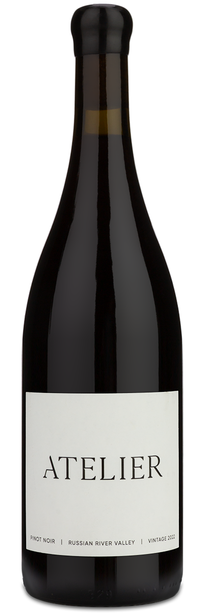 A dark glass wine bottle with a black capsule and a white label reading 'ATELIER' on a plain white background.