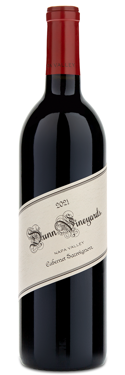 A bottle of Dunn Vineyards 2021 Napa Valley Cabernet Sauvignon with a red foil cap and slanted cream label.