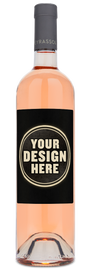 A clear bottle of 2024 Peyrassol Provence Rosé with a custom label, filled with pale pink wine.