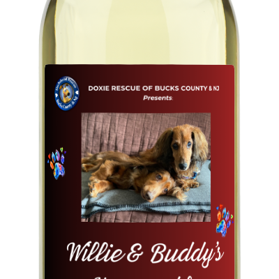 A wine bottle labeled Doxie Rescue | Willie & Buddys Honeysuckle Moscato by personalwine, with a dachshund on a rug.