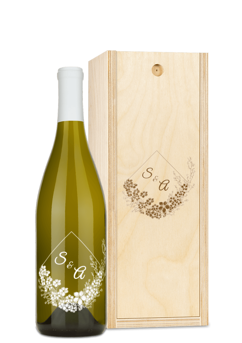 Custom wine bottle and wooden box, both engraved with floral designs and the initials “S & A” visible.
