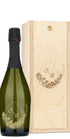 A wine bottle and wooden box, both engraved with floral designs and the initials S & A.