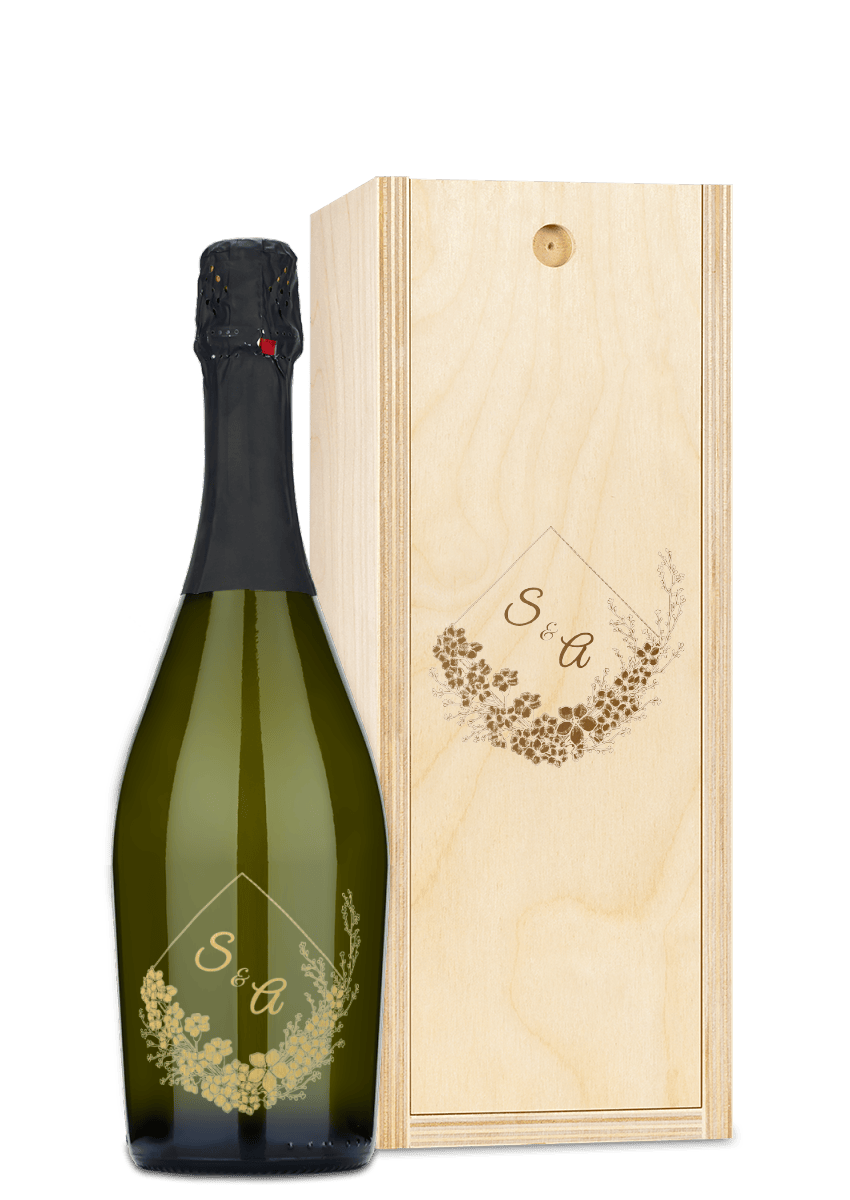 A wine bottle and wooden box, both engraved with floral designs and the initials S & A.