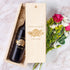 Custom engraved wine and wood box labeled David & Sarah - June 4, 2025 next to a bouquet of flowers.
