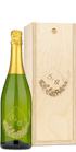 Wine bottle with gold floral “S & A” design alongside a matching engraved wooden box.