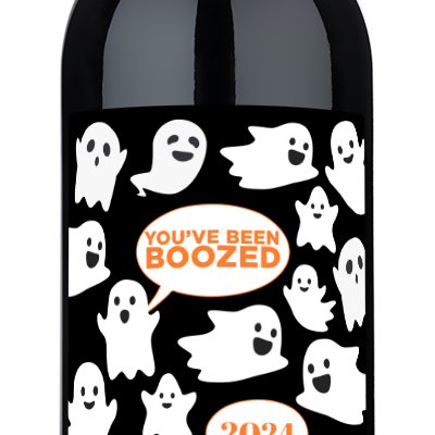 Wine bottle with cartoon ghosts, YOUVE BEEN BOOZED 2024, and a personalized name on the Halloween-themed label.