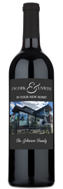 A bottle of wine with a custom label reading Uncork & Unwind, presented as a housewarming gift.