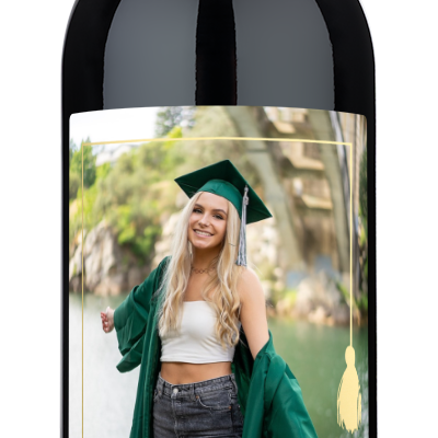 A wine bottle with a graduation-themed label for Mia Smith 2025, displayed in a photo frame with a gold tassel.