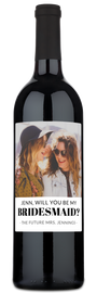 Wine bottle with a label showing two smiling women and the text, Jenn, will you be my bridesmaid?.
