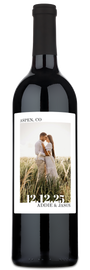 A wine bottle with a label showing a couple kissing, their names Addie & Jason, and Aspen, CO 12.12.25 printed below.