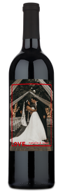Personalized wine bottle labeled LOVE - natalie & rahul with a wedding photo in a Love Frame.