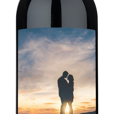 Wine bottle with custom label showing a couple kissing and the word love written below them.