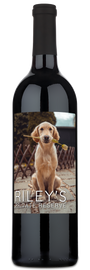 Wine bottle with a label showing a puppy holding a flower and custom text.