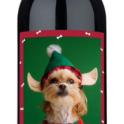 Wine bottle with a label showing a dog wearing antlers and Happy Howlidays holiday greeting.