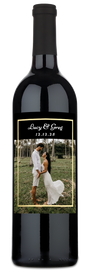 Wine bottle with a gold frame wedding photo label reading Lucy & Greg 12.12.25.