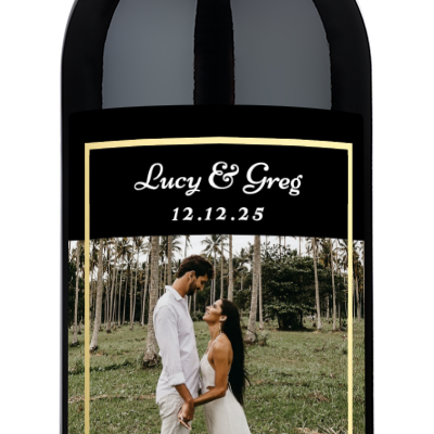 Wine bottle with a gold frame wedding photo label reading Lucy & Greg 12.12.25.