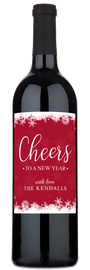 A wine bottle with a red label decorated with white snowflakes and Cheers to a New Year text.