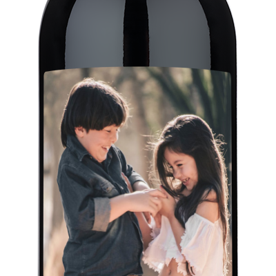 Two smiling children on a wine label with cheerful blue and orange Happy Everything text.
