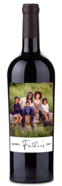 Bottle of wine with a custom label showing a family photo and the text “Happy Father’s Day.”.