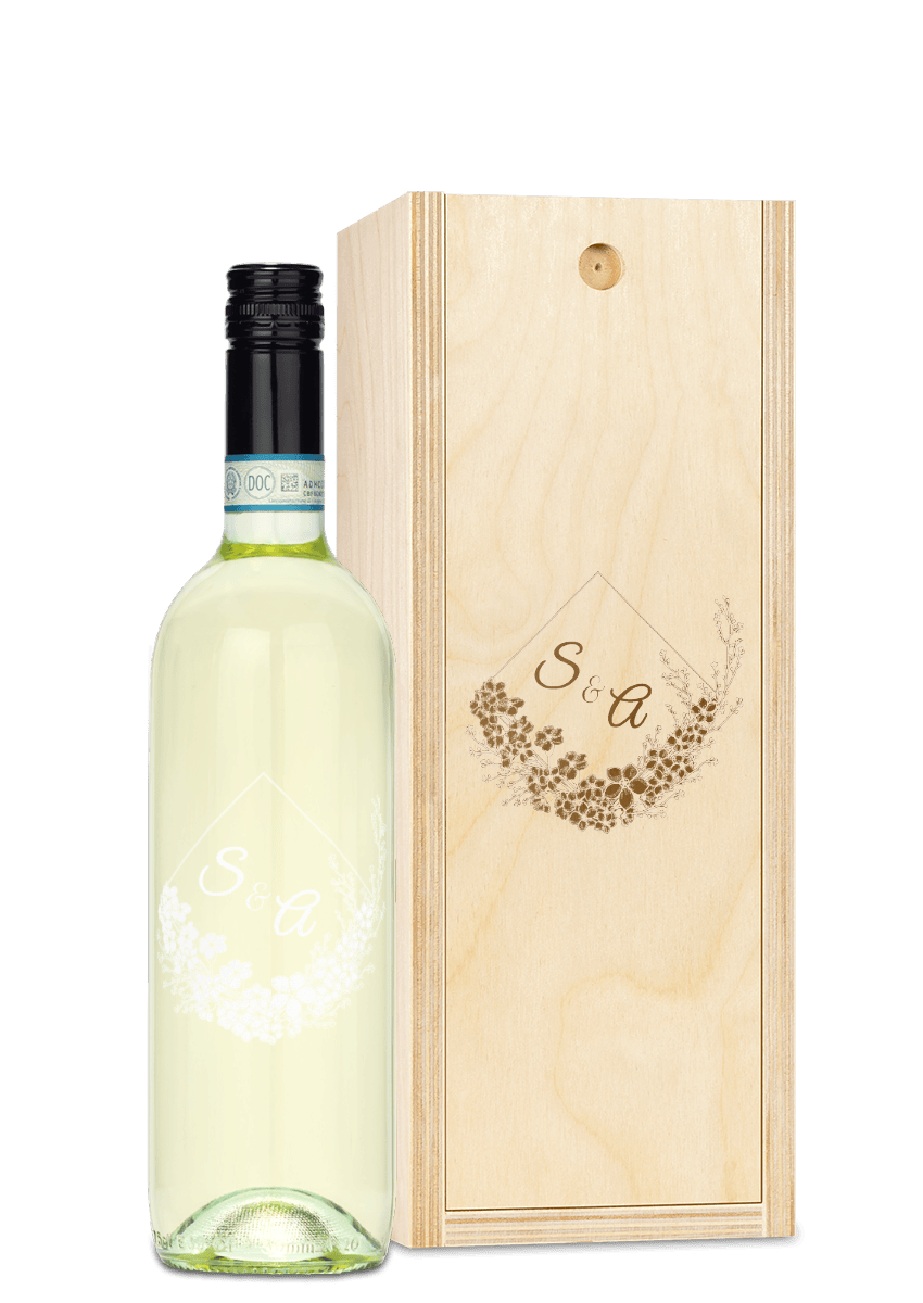 A wooden wine box and bottle, both engraved with floral designs and the initials S & A.