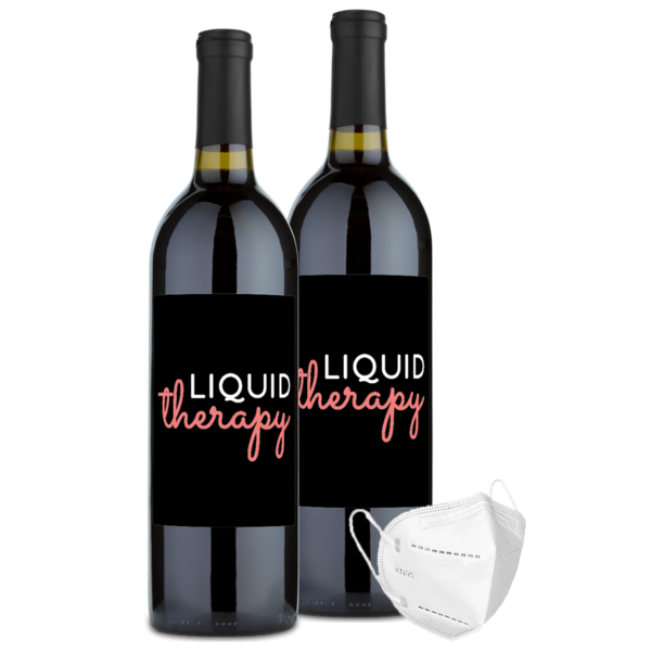 A bottle of Cabernet Sauvignon labeled Liquid Therapy with two decorative face masks beside it.