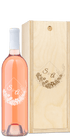 Engraved wood box and floral wine bottle labeled S&A, both displayed together.