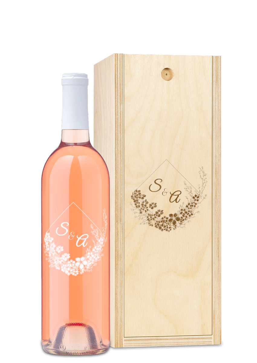 Engraved wood box and floral wine bottle labeled S&A, both displayed together.