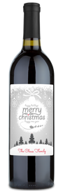 Wine bottle with a festive Christmas ornament label, Merry Christmas and The Claus Family in red at the bottom.
