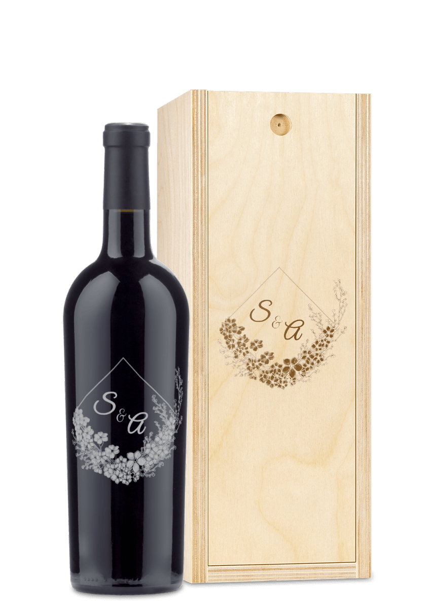 Custom engraved wine and wood box with floral patterns and the initials S & A on the surface.
